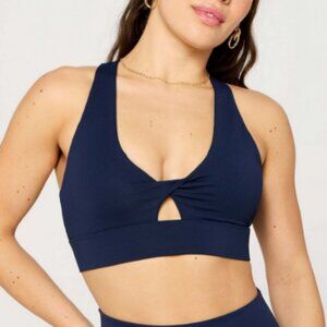 Fabletics Oasis Twist Medium Impact Sports Bra in Deep Navy